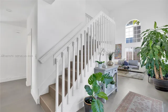 a living room with furniture and a potted plant