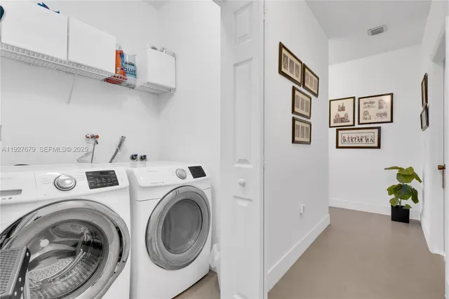 a view of a storage & utility room with dryer and washer