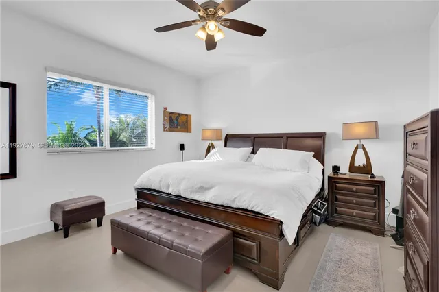 a spacious bedroom with a bed and a chandelier