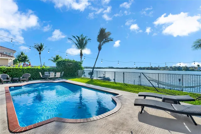 a view of a workspace with furniture and a flat screen tv