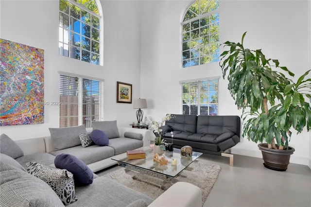 a living room with furniture and a potted plant