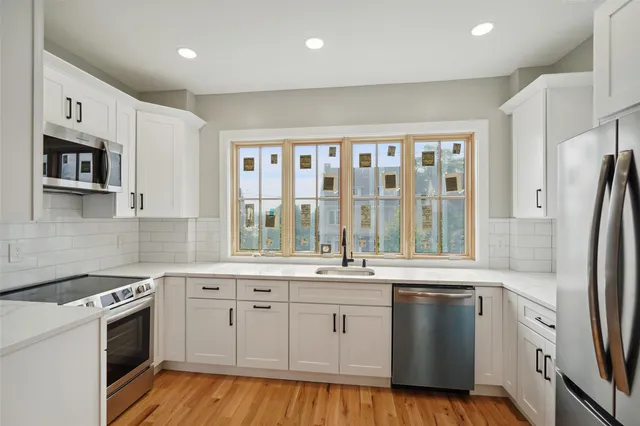 a kitchen with a sink stove and refrigerator
