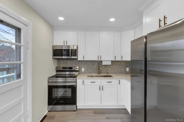 a kitchen with stainless steel appliances granite countertop a stove a refrigerator and a microwave