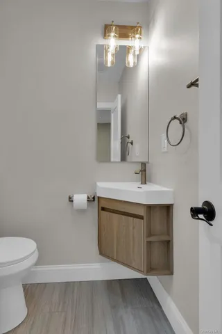 a bathroom with a sink vanity and a toilet