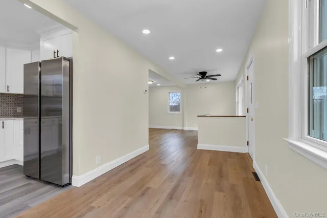 a view of a refrigerator in kitchen and wooden floor