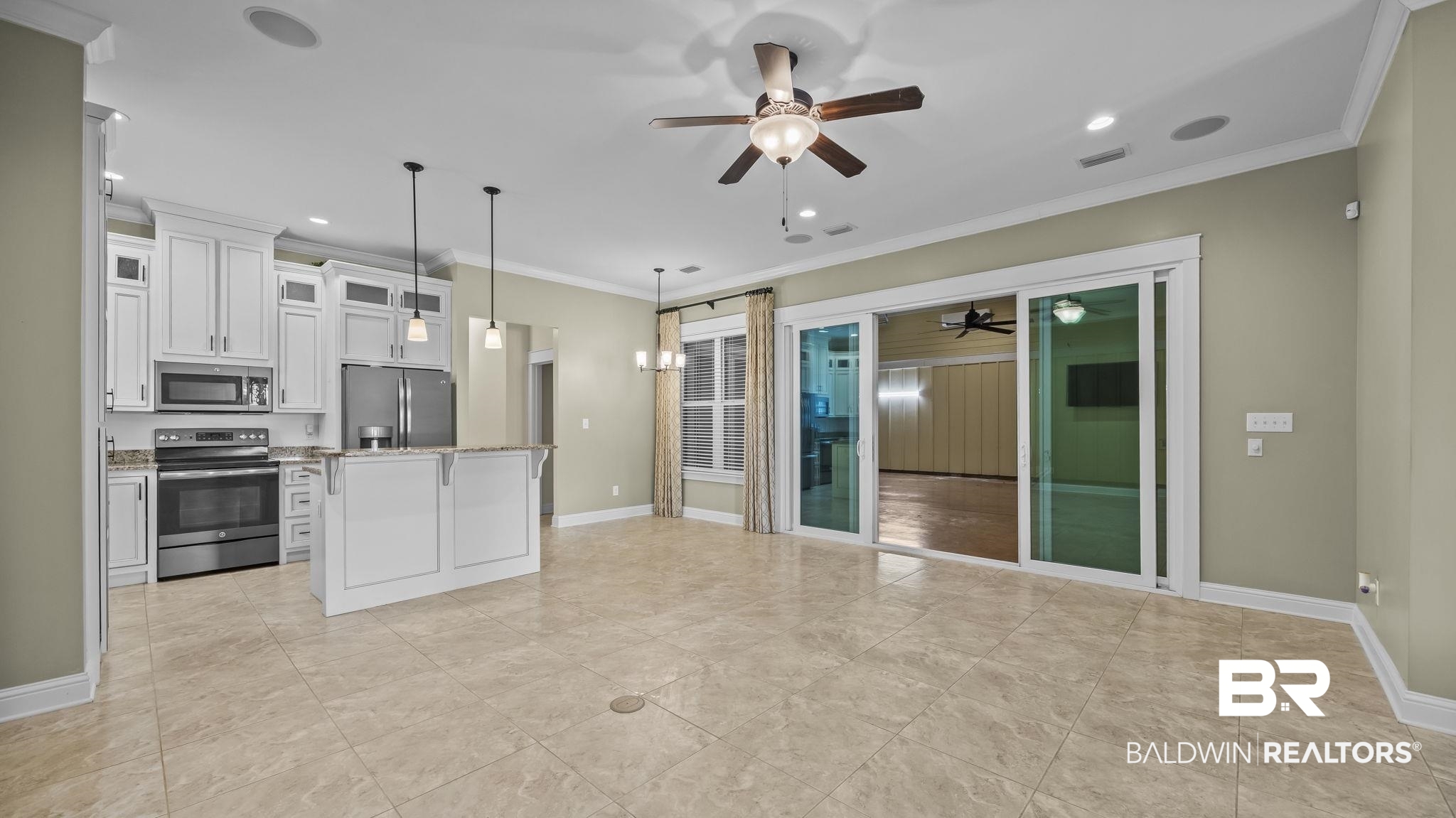 12361 Reunion Place Foley, AL 36535 - Photo 8 of 43 Kitchen with glass insert cabinets, appliances with stainless steel finishes, white cabinets, a kitchen island, and hanging light fixtures