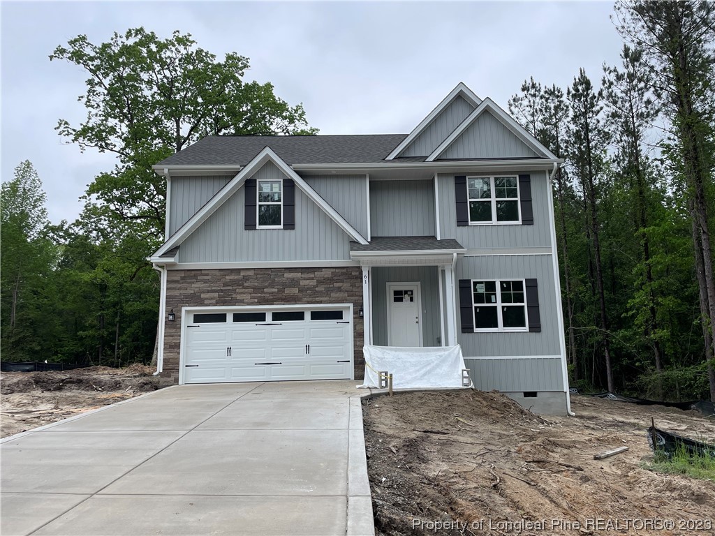 61 Solomon Drive Cameron, NC 28326 - Photo 1 of 7 a front view of a house with a yard and garage