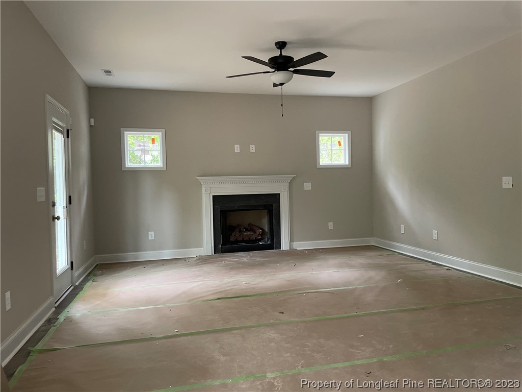 61 Solomon Drive Cameron, NC 28326 - Photo 3 of 7 a view of an empty room with window and fire place