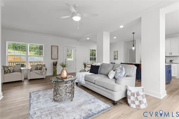 a living room with furniture and wooden floor