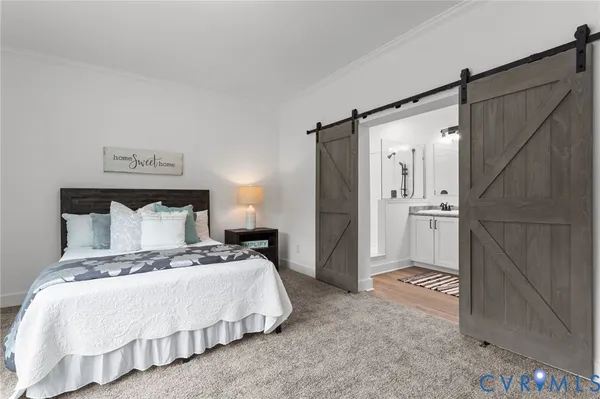a bedroom with a bed and a couch