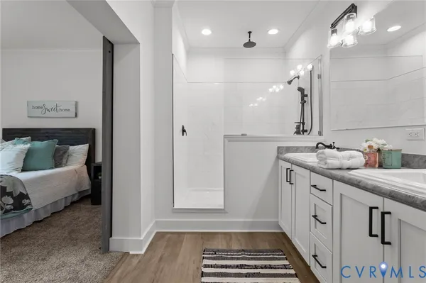 a bathroom with a granite countertop sink a toilet and bathtub