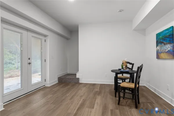 a view of an entryway with wooden floor and a livingroom view