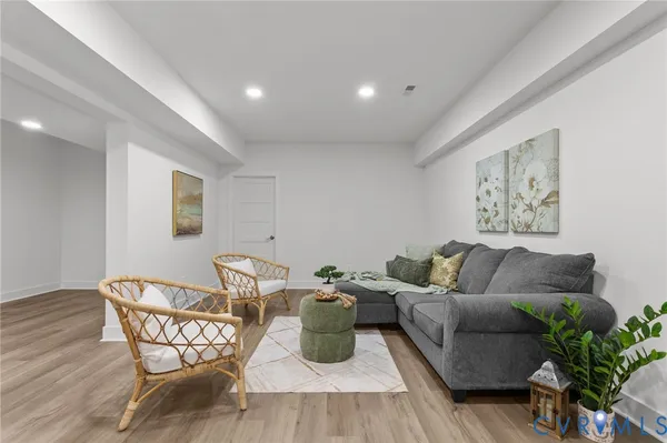 a living room with furniture and a wooden floor