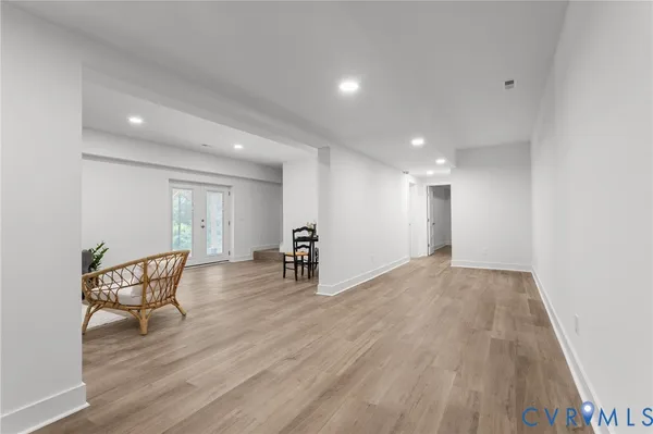 a living room with furniture and a wooden floor