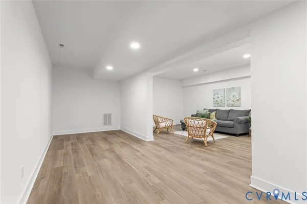 a view of an empty room with wooden floor