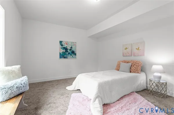 a spacious bedroom with a bed and a window