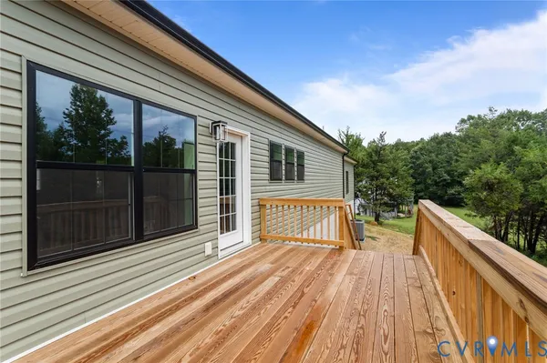 a balcony with wooden floor and fence