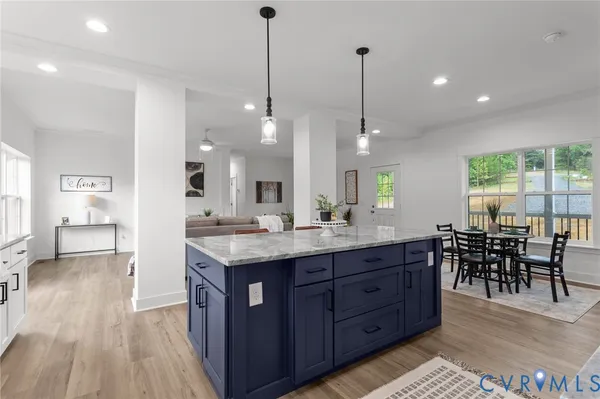 a large kitchen with lots of counter space a sink dining table and chairs