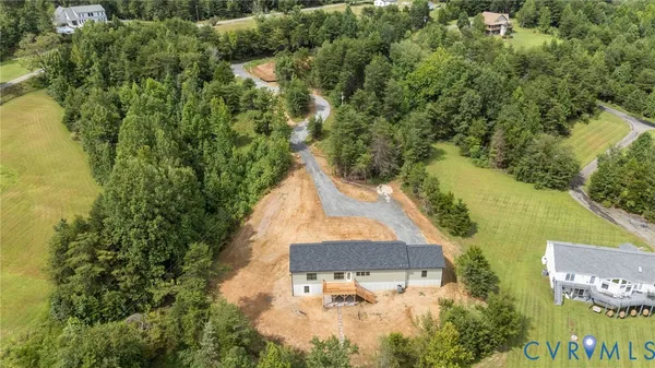 an aerial view of a houses with a lake view