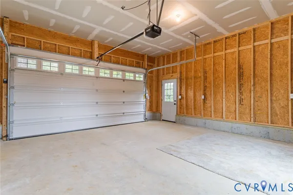 a kitchen with stainless steel appliances a dining table chairs refrigerator and microwave
