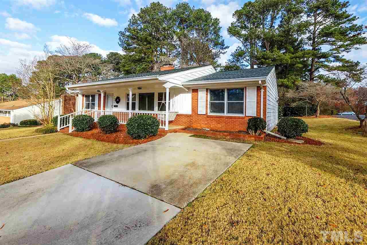 5004 Kaplan Drive Raleigh, NC 27606 - Photo 2 of 30 a front view of a house with a yard and potted plants