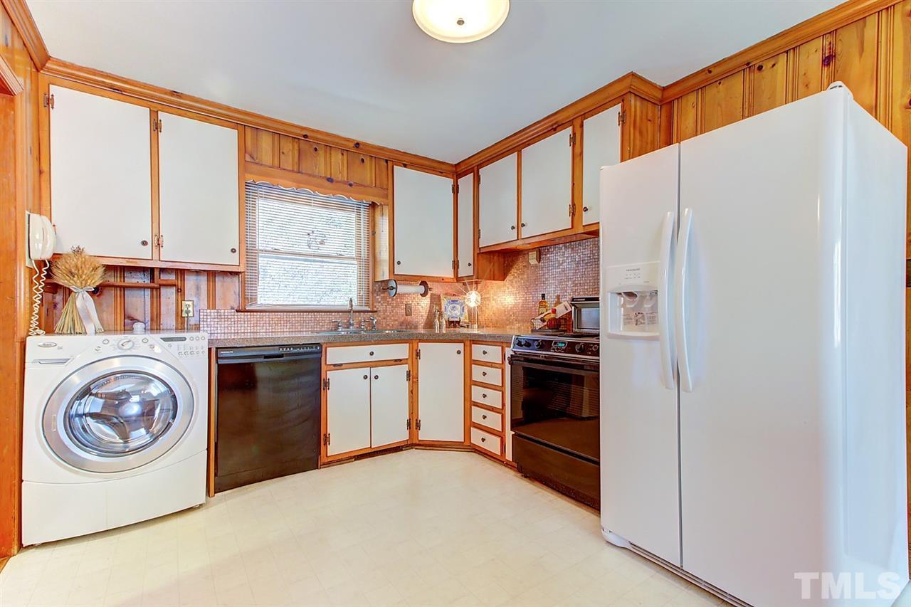 5004 Kaplan Drive Raleigh, NC 27606 - Photo 14 of 30 a kitchen with stainless steel appliances granite countertop a stove a sink and a refrigerator