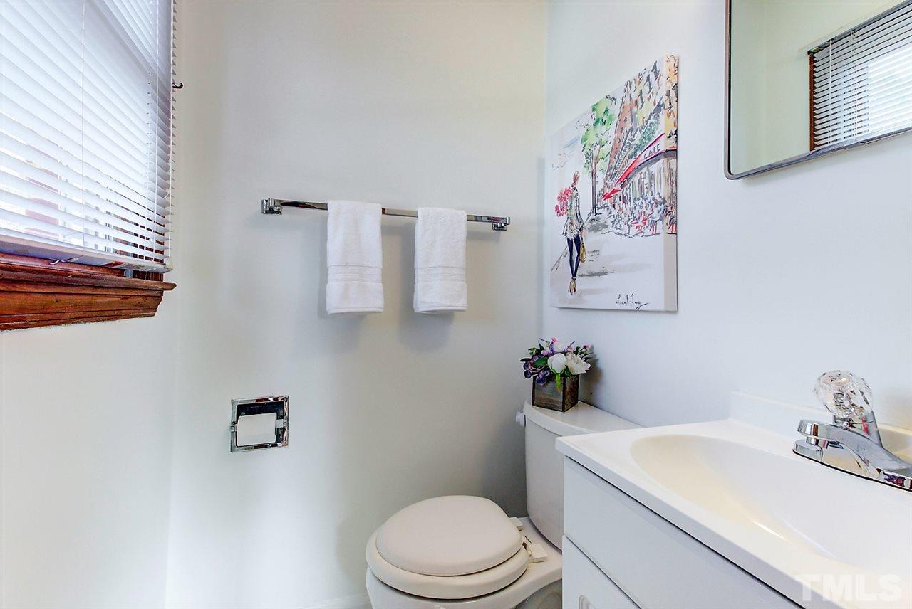 5004 Kaplan Drive Raleigh, NC 27606 - Photo 20 of 30 a bathroom with a sink mirror vanity and toilet