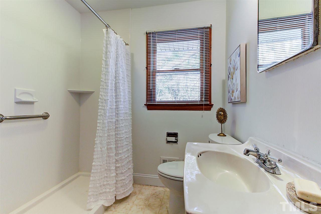5004 Kaplan Drive Raleigh, NC 27606 - Photo 23 of 30 a bathroom with a sink a toilet and shower