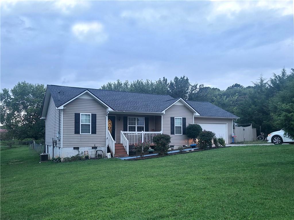 a front view of house with yard and green space