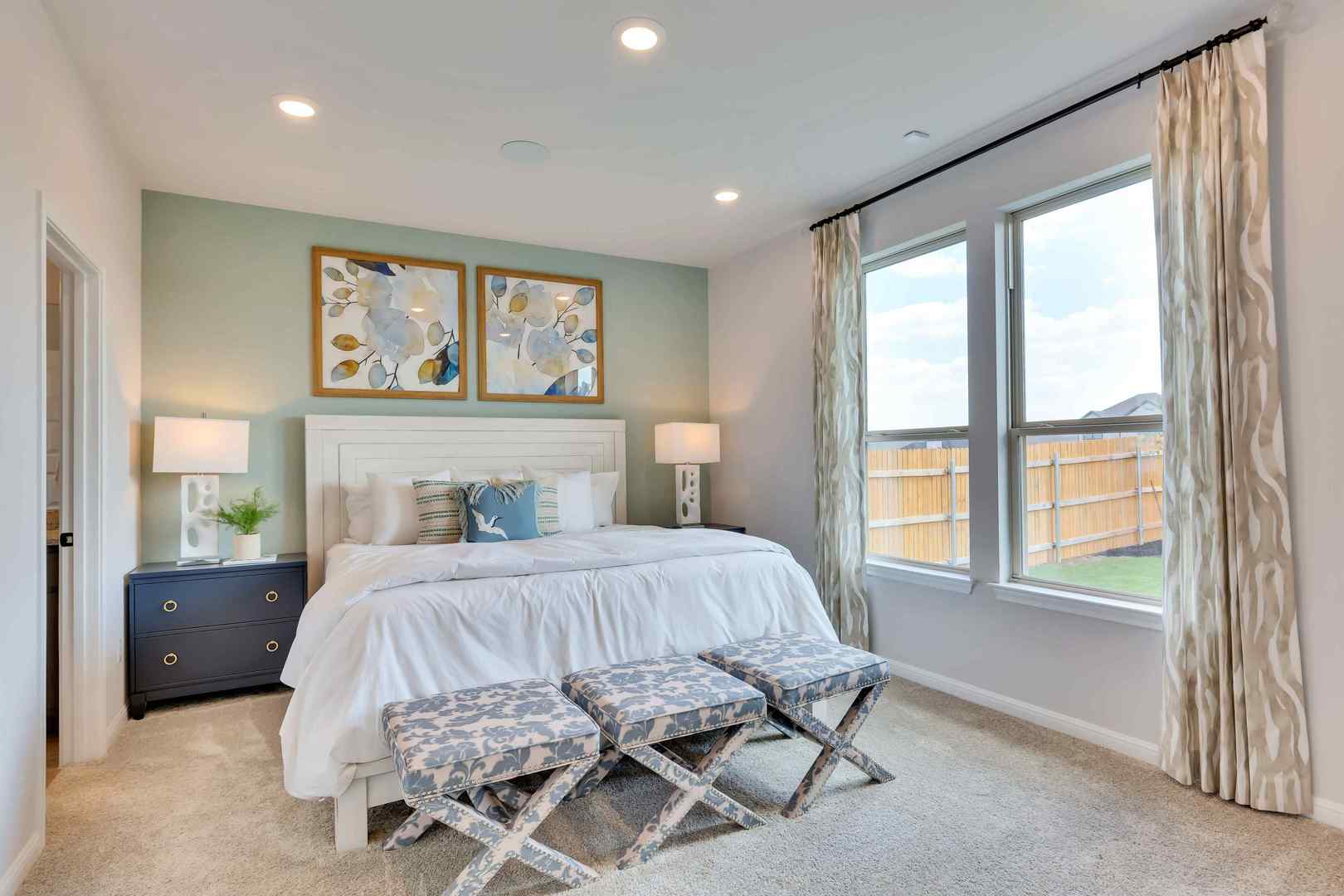 1205 Lavender Way Georgetown, TX 78628 - Photo 12 of 14 Recessed lighting illuminates a comfortable bedroom, showcasing ample natural light from generous windows.