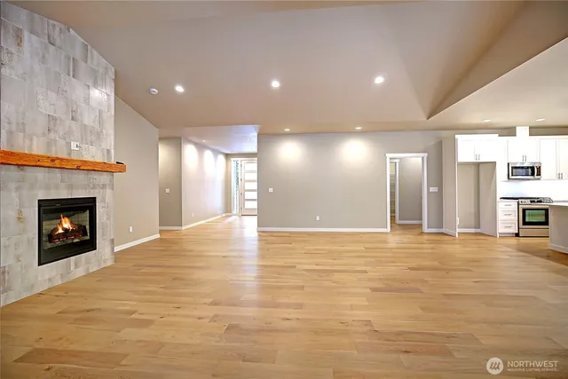a view of an empty room with a fireplace