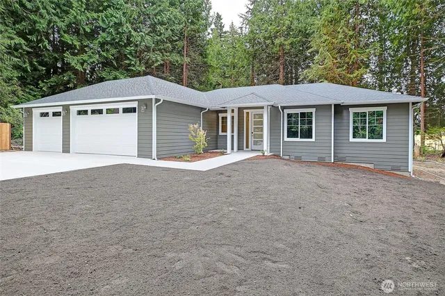 a front view of a house with a garden and yard