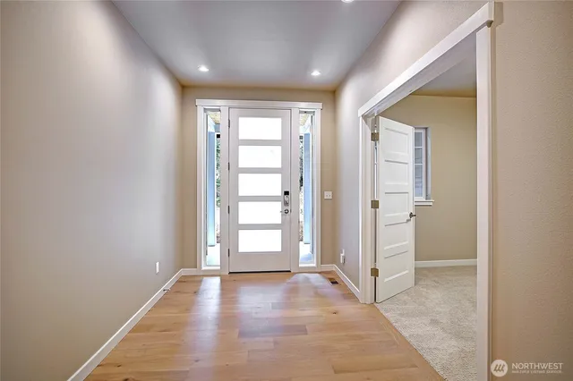 an empty room with windows and closet