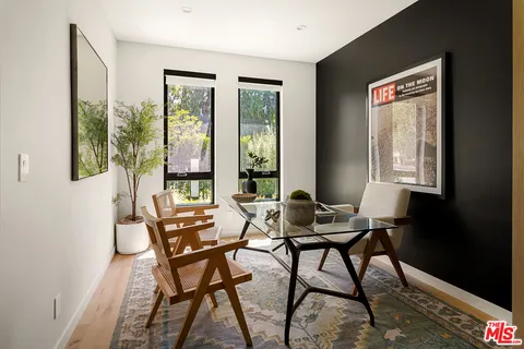 a living room with furniture and a painting
