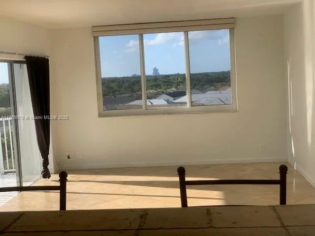 a view of a floor with wooden floor and a window