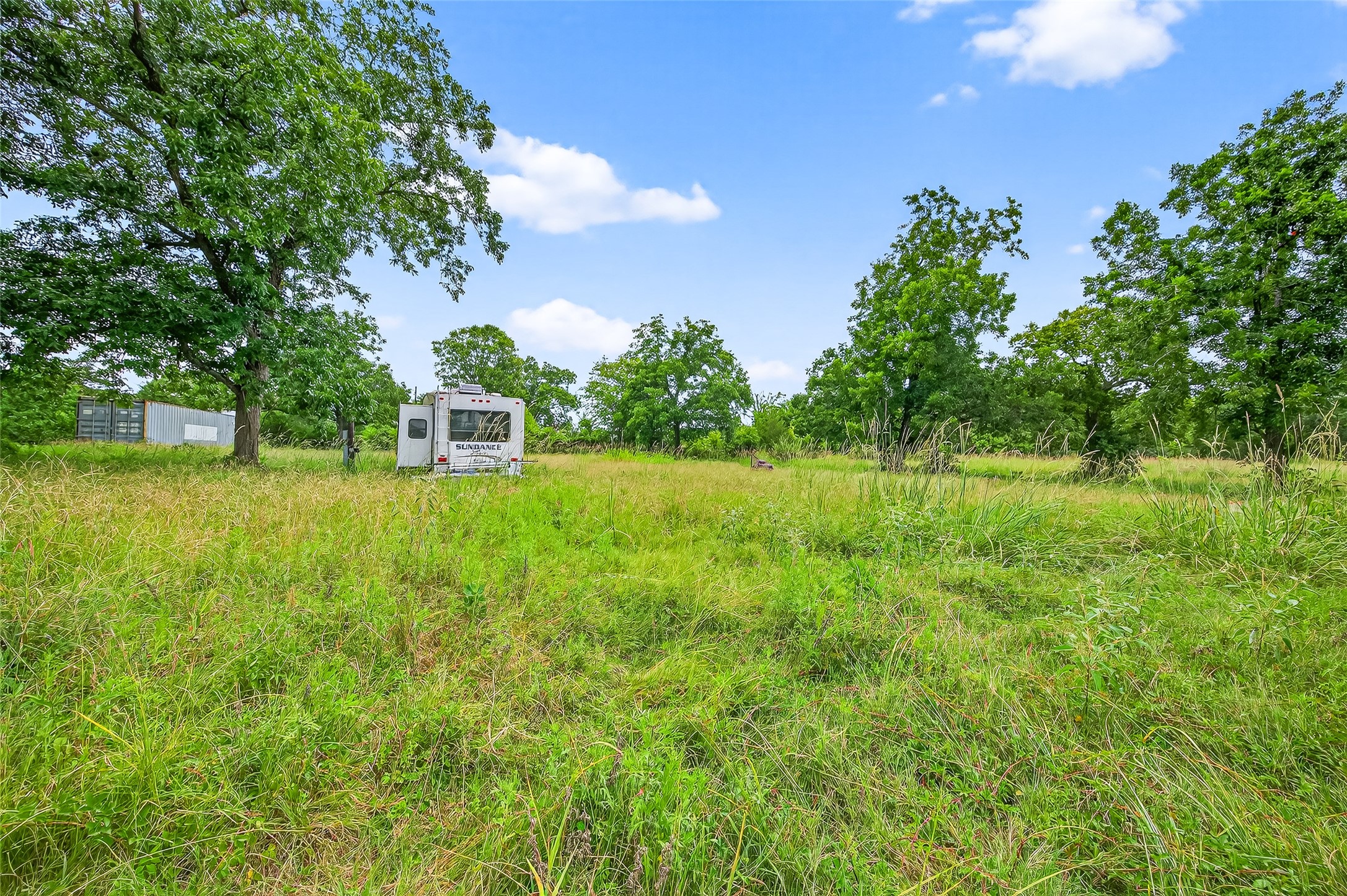 14132 North Old Highway 35 Road Moscow, TX 75960 - Photo 17 of 18 a backyard of a house with lots of green space and garden view