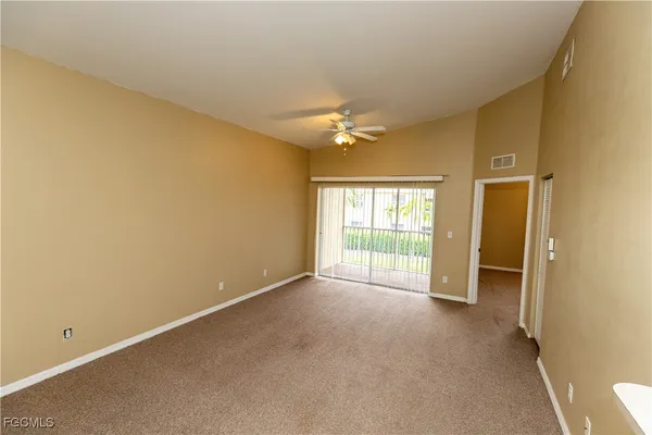an empty room with a empty space and a ceiling fan
