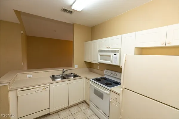 a kitchen with stainless steel appliances a refrigerator sink and stove