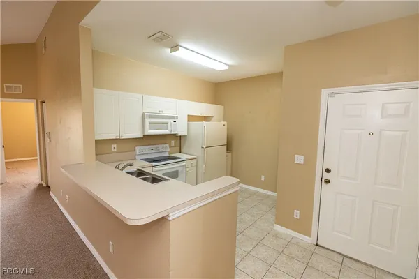 a kitchen that has a sink and a stove
