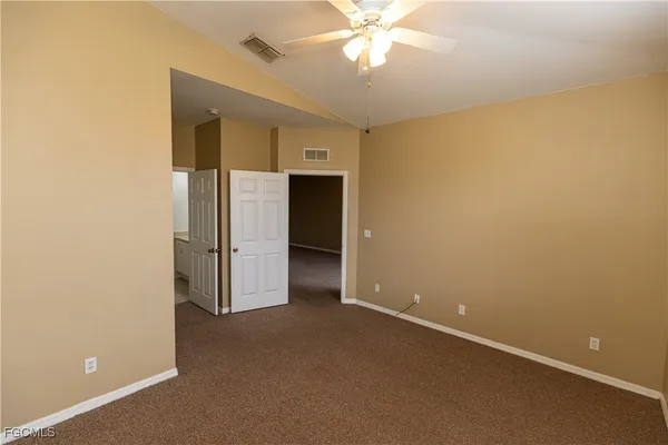 an empty room with a empty space and a ceiling fan