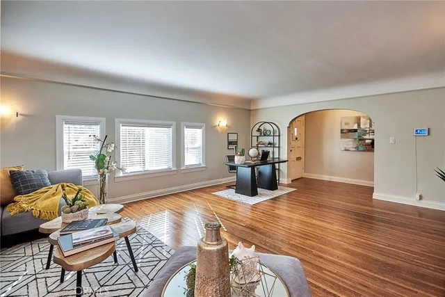 a view of a livingroom with furniture window and wooden floor