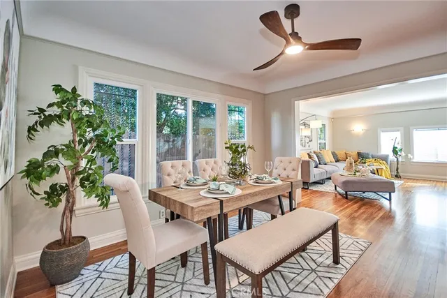 a view of a dining room with furniture window and wooden floor