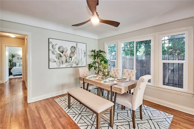 a living room with furniture potted plant and a large window