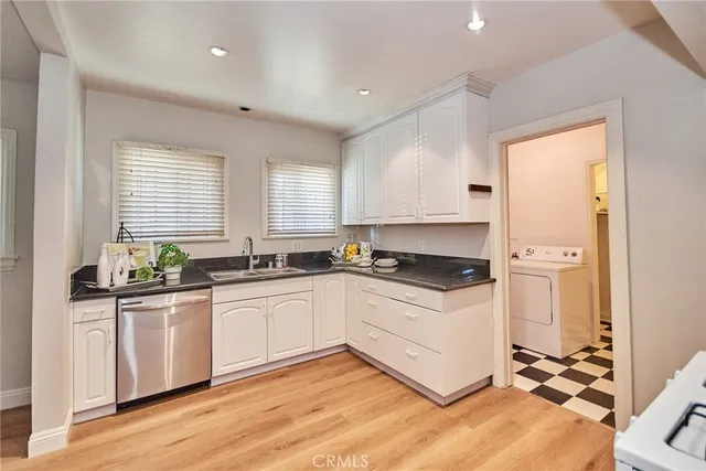 a kitchen with stainless steel appliances granite countertop a sink and cabinets