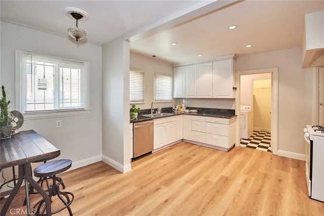 a view of a room with gym equipment and wooden floor