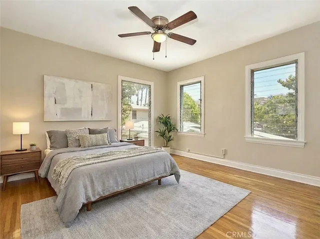 a bedroom with a large bed and a potted plant