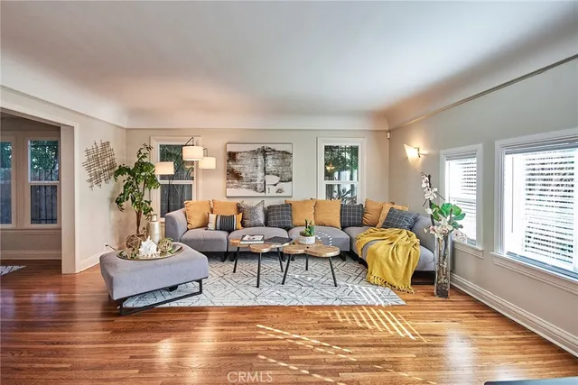 a living room with furniture a flat screen tv and a large window