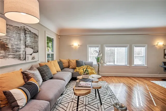 a living room with fireplace furniture and a wooden floor