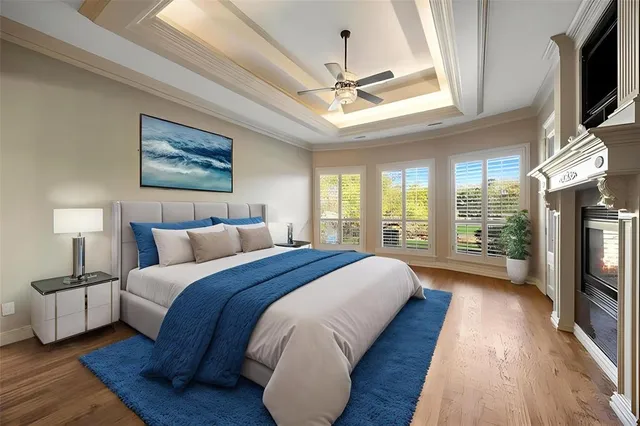 a spacious bedroom with a bed a flat screen tv and a large window