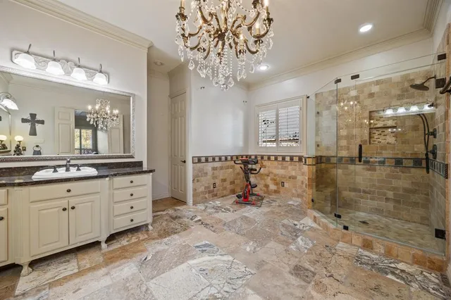 a bathroom with double vanity and a mirror